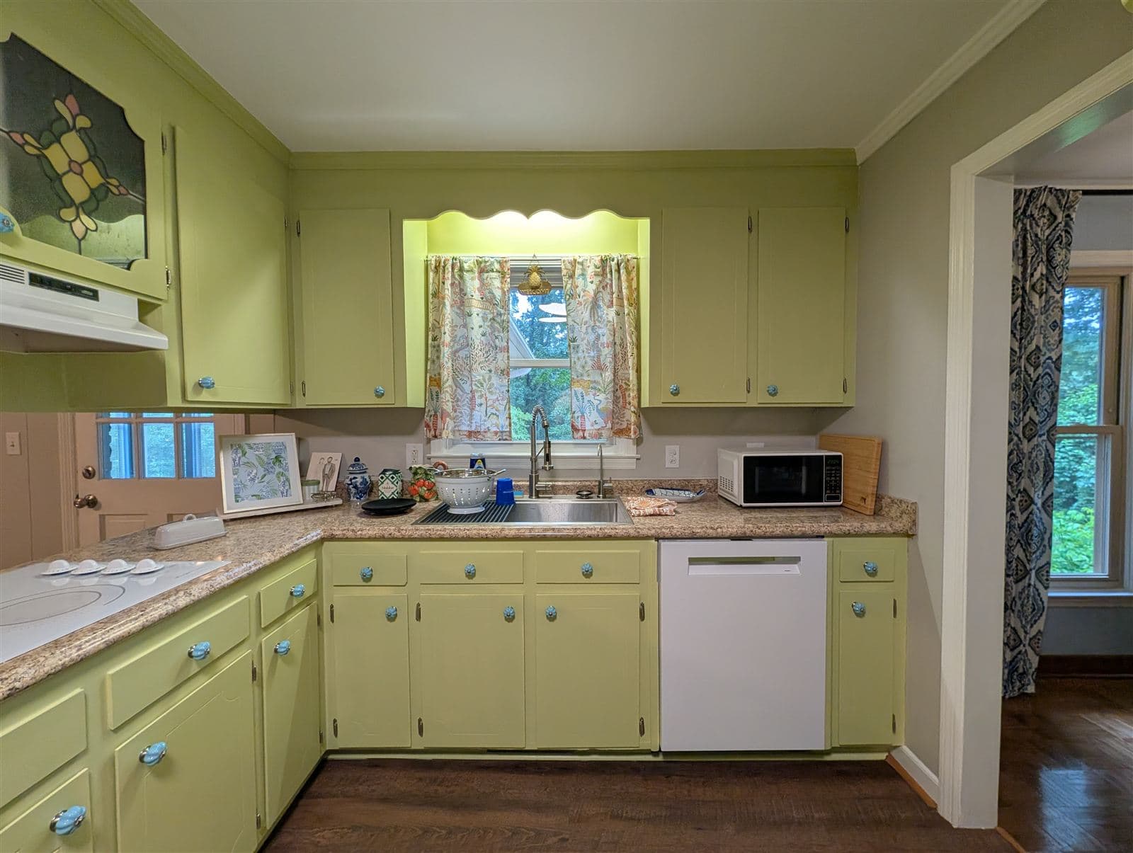Kitchen cabinets original to the house repainted in a soft green in Taylors, SC