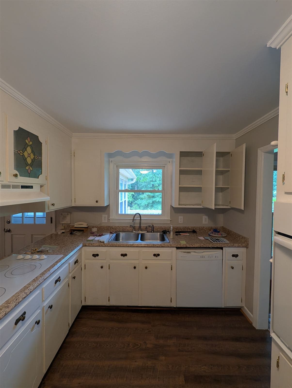 Kitchen before — original cabinets in dingy brush-painted white in Taylors, SC