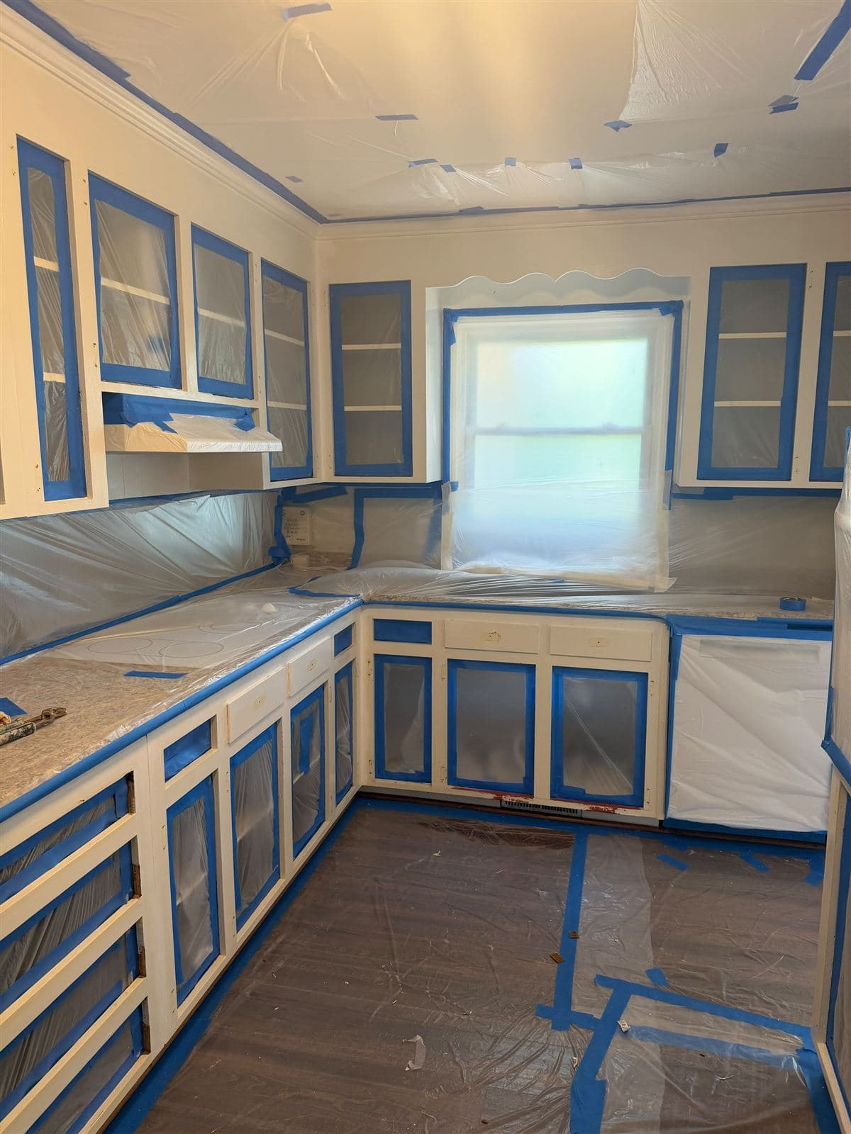 Kitchen fully masked in plastic for cabinet spraying in Taylors, SC