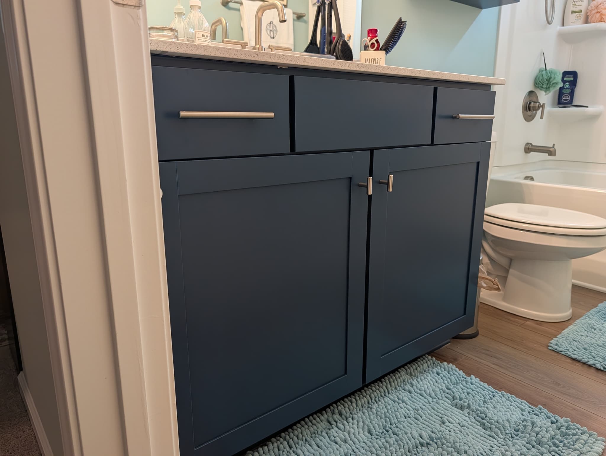 Navy-painted bathroom vanity beside a tub in a Simpsonville home