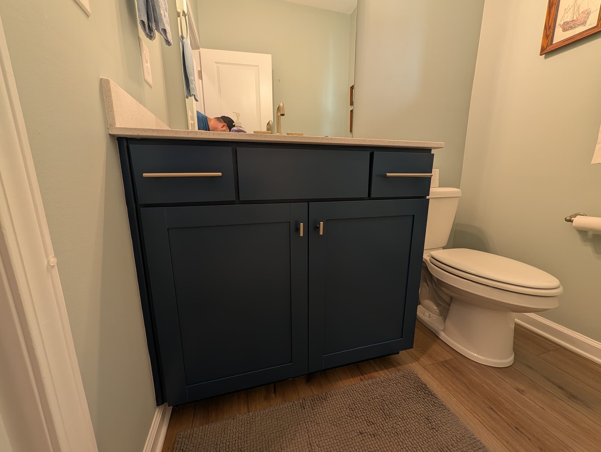 Single bathroom vanity sprayed navy with brushed-nickel handles