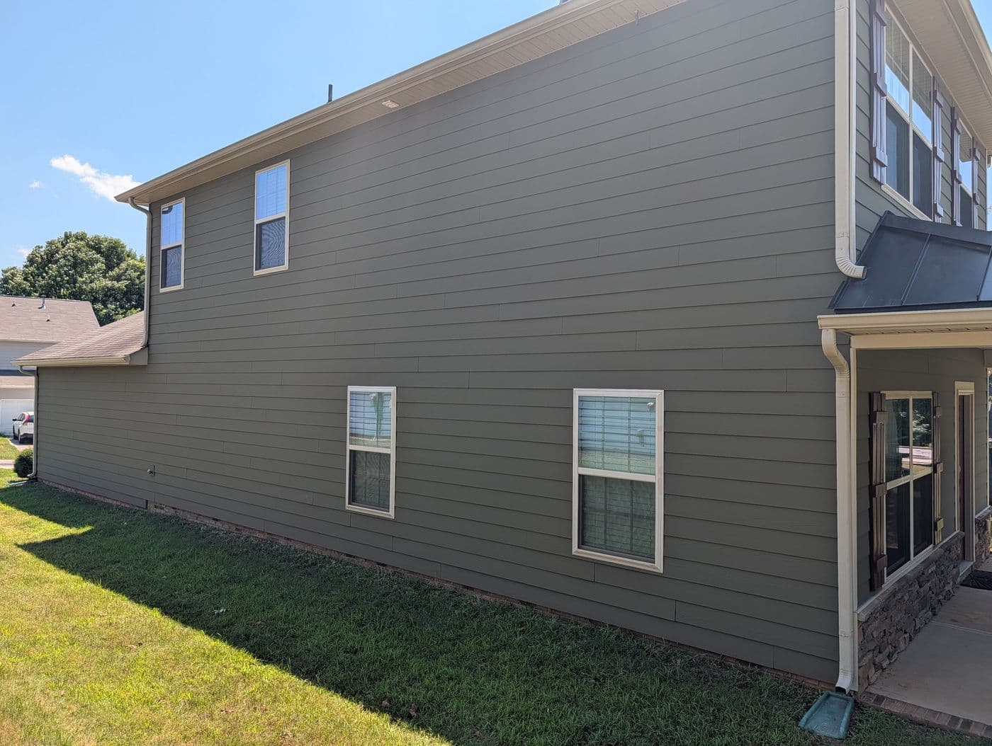 Full side elevation of the repainted home showing repaired siding in Simpsonville, SC