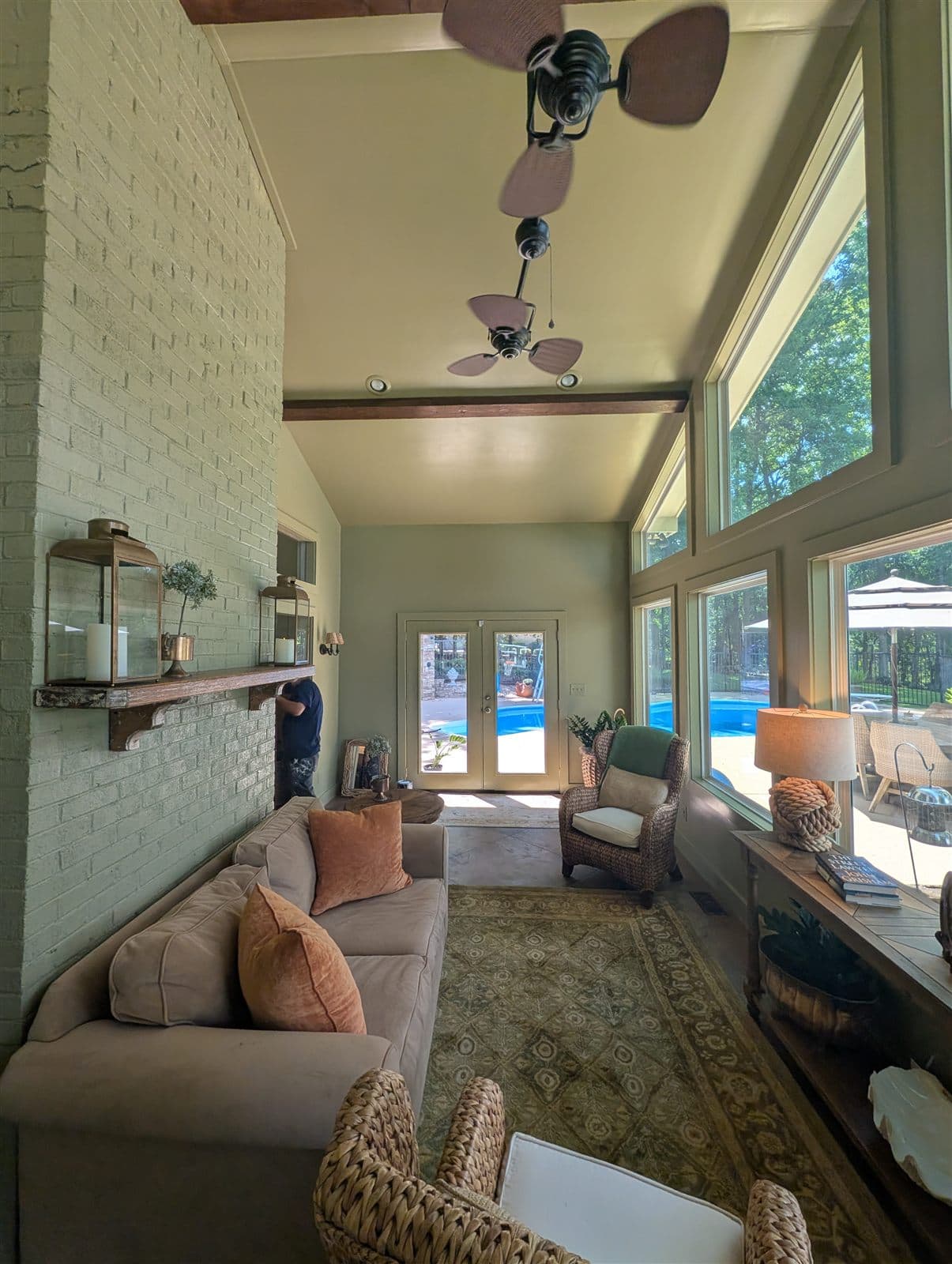 Painted brick fireplace wall and mantel in the finished lake room looking toward the pool doors