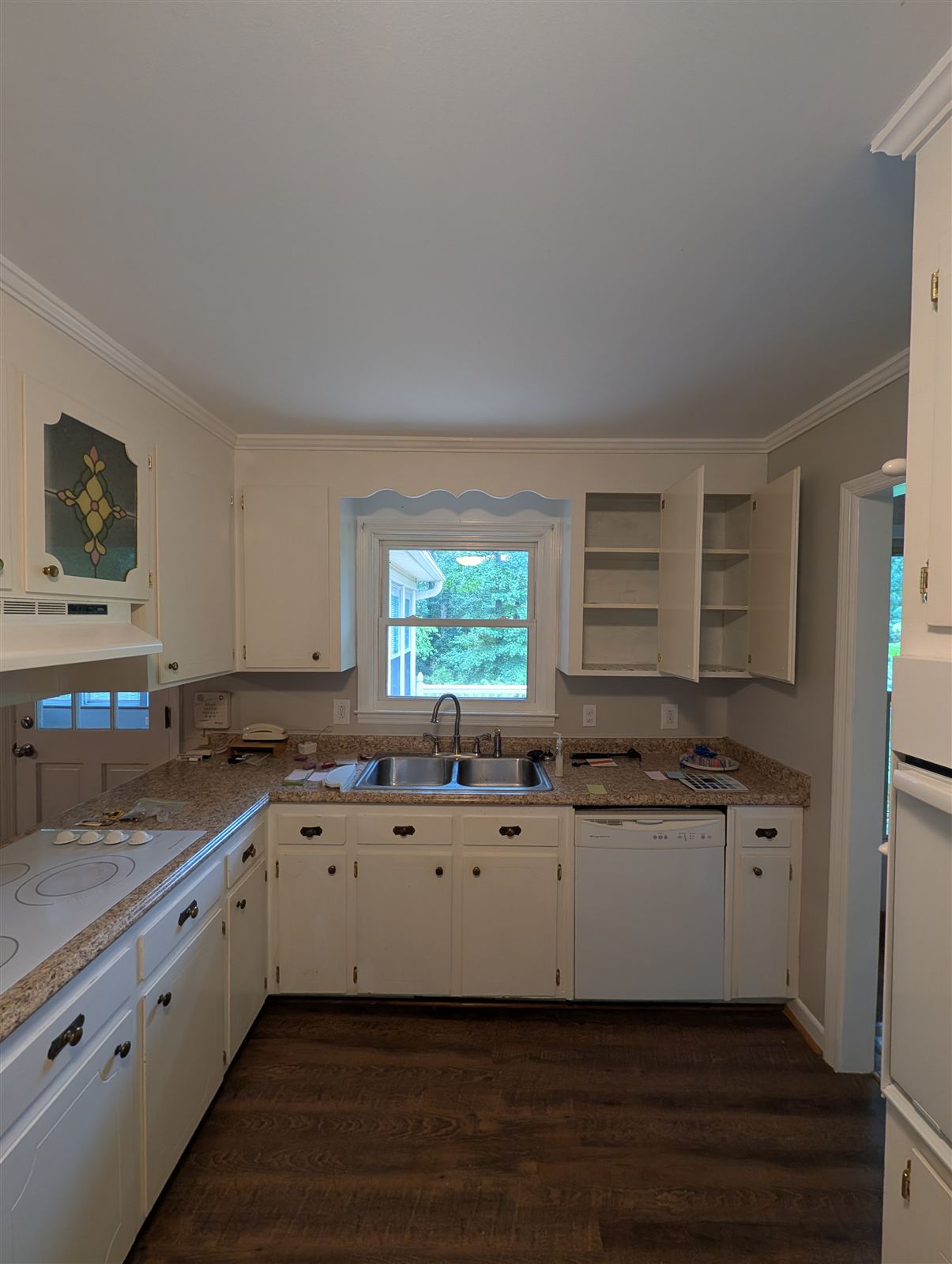 Kitchen before — original cabinets in dingy brush-painted white in Taylors, SC