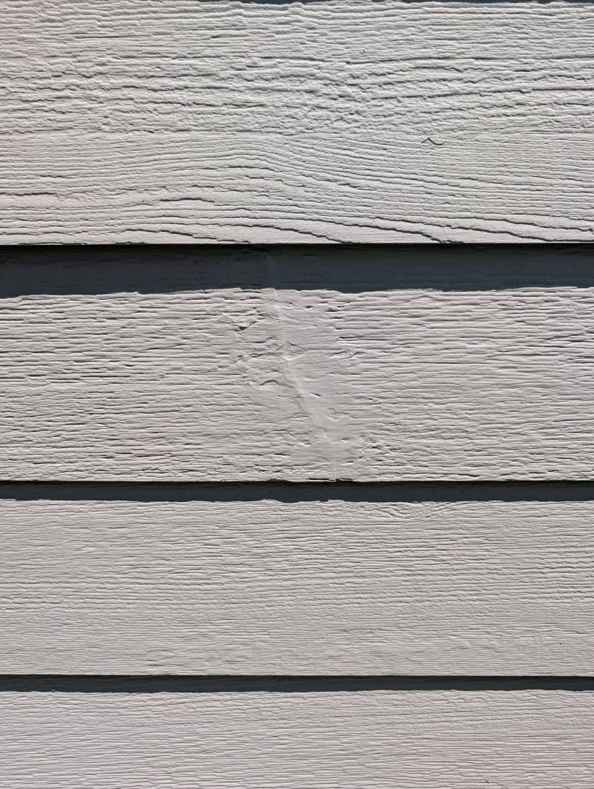 Close-up of a repaired siding crack sealed and painted in Simpsonville, SC